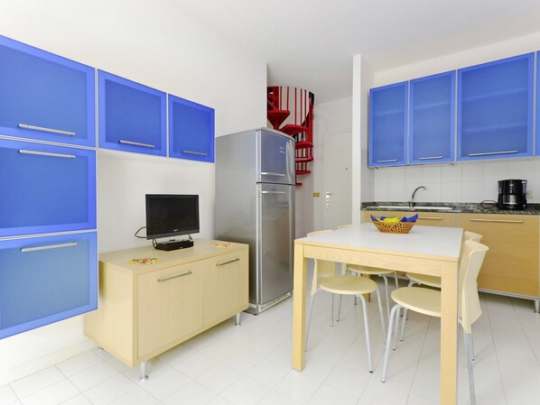 Fridge, microwave, cookware/dishes/utensils, dining tables
