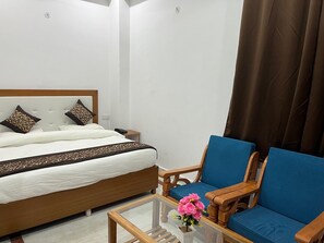Relax in a cozy space with a comfortable bed, nightstands, and a stylish armchair.
