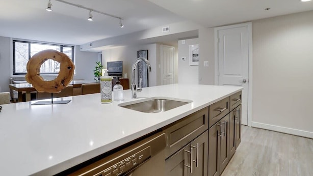 Una cocina moderna con una isla grande, electrodomésticos de acero inoxidable y un diseño minimalista.