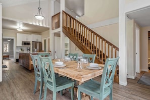 Enjoy meals with family and friends in this dining area, featuring a large table and six matching chairs.