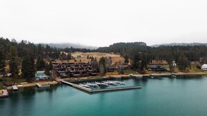 A lakeside lodge with multiple cabins and a dock area.