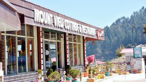 A restaurant with a sign reading "MOUNT VIEW COTTAGE & RESTAURANT" and potted plants in front. - Mount View Dhanaulti Dreams (Dhanaulti)