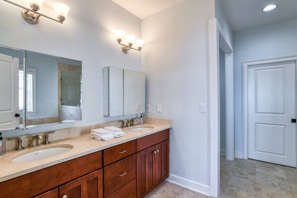 A bathroom with two sinks, a large mirror, and wooden cabinets. - Waterfront! Incredible Views, Watch the Dolphins Play, Perfect for Groups, $300 in Free Tickets! (St. Augustine)