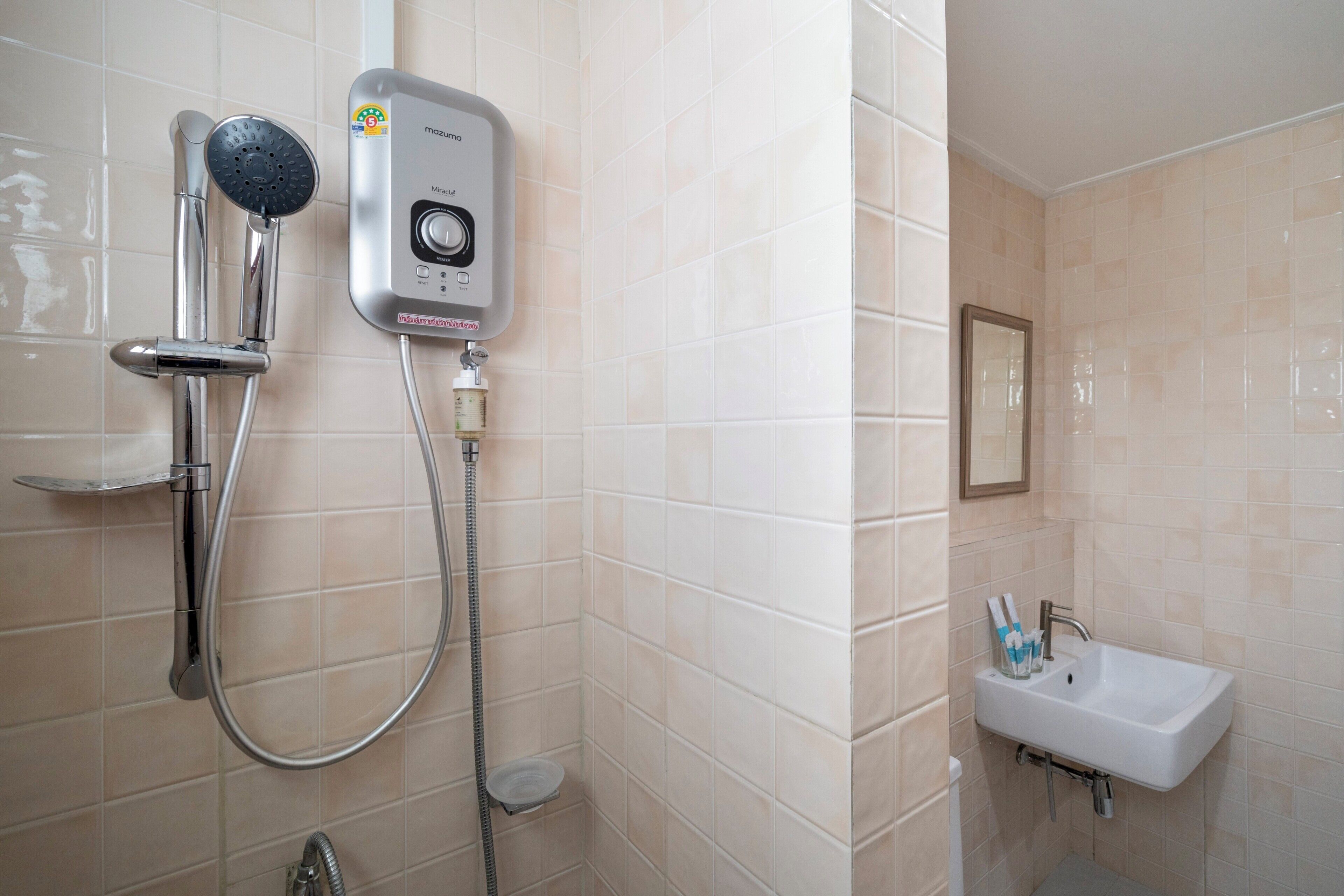 A bathroom with a shower, a sink, and a mirror.