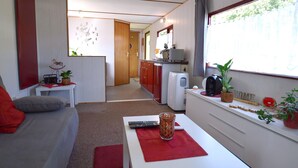 A compact living space with a kitchenette, a dining area, and a seating area. - Apartment in Meisberg With In-house Catering (Meisburg)