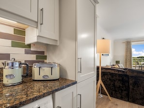 A kitchenette with a toaster, kettle, and a lamp. - 4 Harbour Heights Panoramic Bay Views (Clifden)