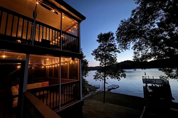 Lakeside escape with a cozy, string-lit porch and stunning sunset views