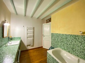 A bathroom with two sinks, a bathtub, and a towel rack. - Charming Holiday Home With Garden in the Cotentin (Fierville-les-Mines)