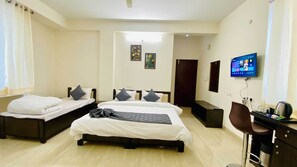 Deluxe Triple Room, City View | Desk, laptop workspace, soundproofing, free WiFi