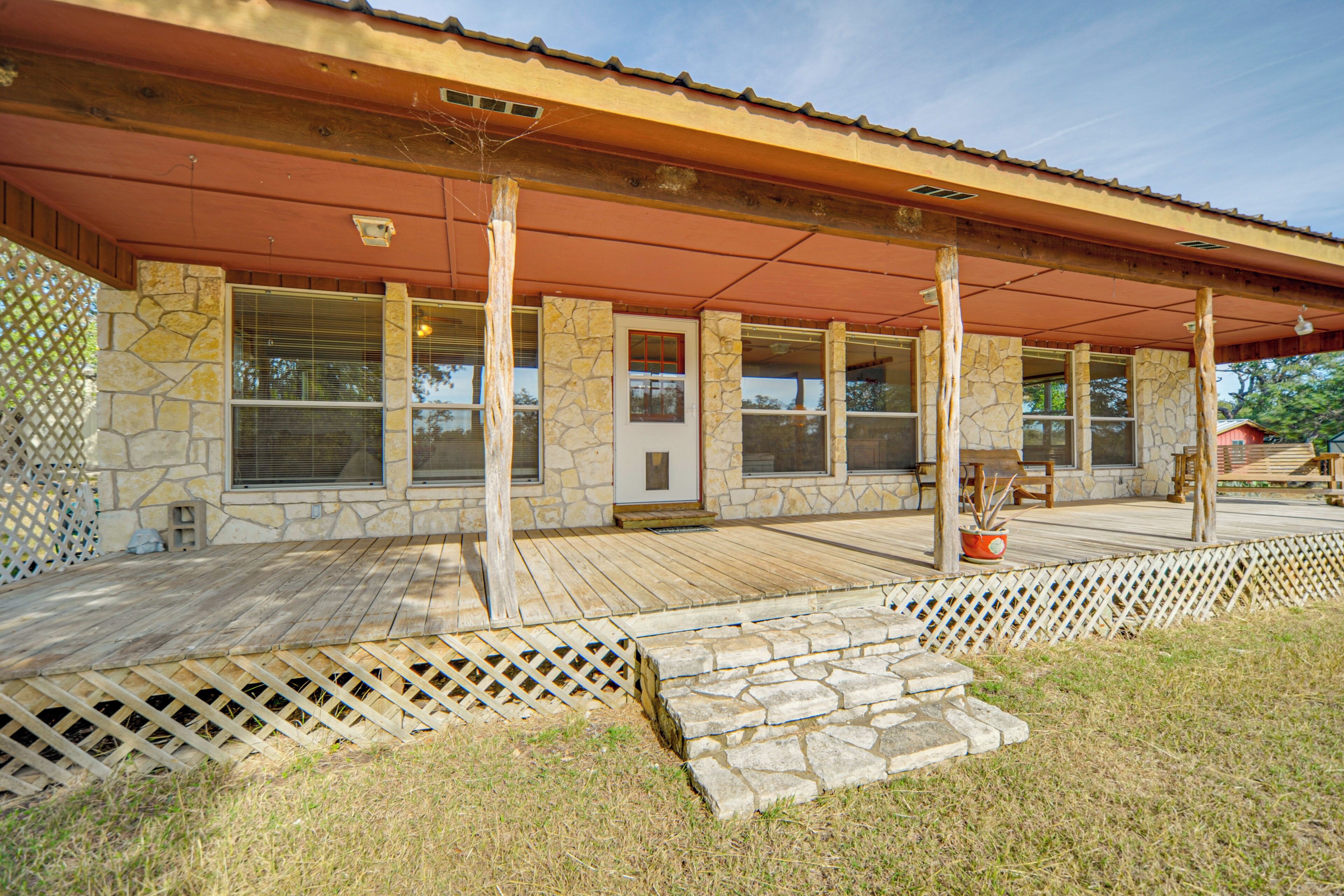 A stone building with a wooden deck and a covered porch.