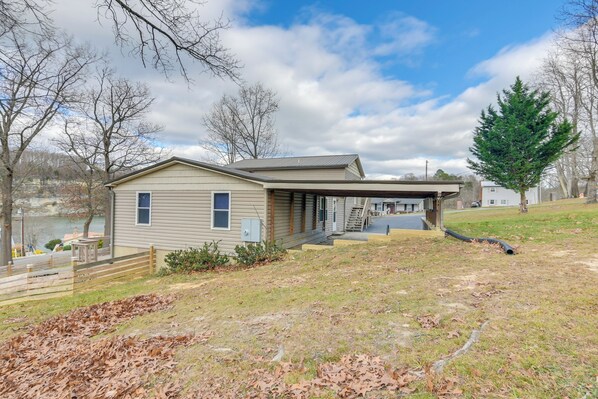 A single-story house with a covered porch, a small deck, and a garage.