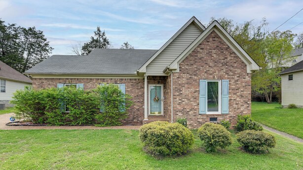 A two-story brick house with a gabled roof, a front porch, and a small front yard with trimmed bushes. - 3 Mi to Old Hickory Lake: Family-friendly Getaway! (Old Hickory)