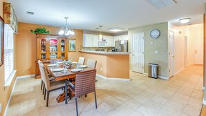 A spacious kitchen with a central island, a dining area with a wooden table and chairs, and a clock on the wall. - 3 Mi to Old Hickory Lake: Family-friendly Getaway! (Old Hickory)