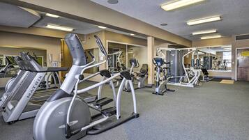 A gym with treadmills, elliptical machines, and weight machines.