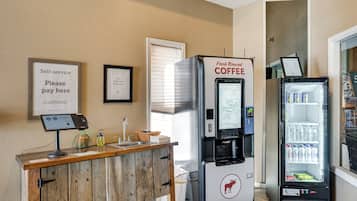 A self-service coffee station with a refrigerated beverage dispenser and a refrigerated drink cooler.