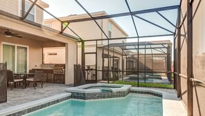 A backyard with a swimming pool, patio furniture, and a hot tub. - 16235 Luxury Retreat Your Perfect Getaway Family Home (Clermont)