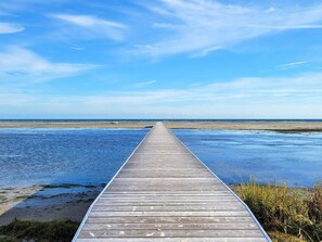 A wooden pier extending into a calm body of water with a clear sky above. - 7 Person Holiday Home in Hadsund (Hadsund)