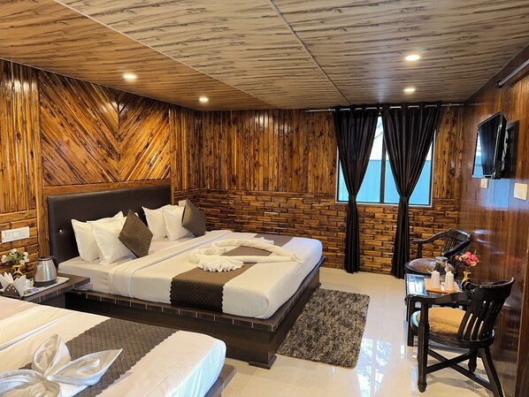 A hotel room with a bed, a desk, and a chair.