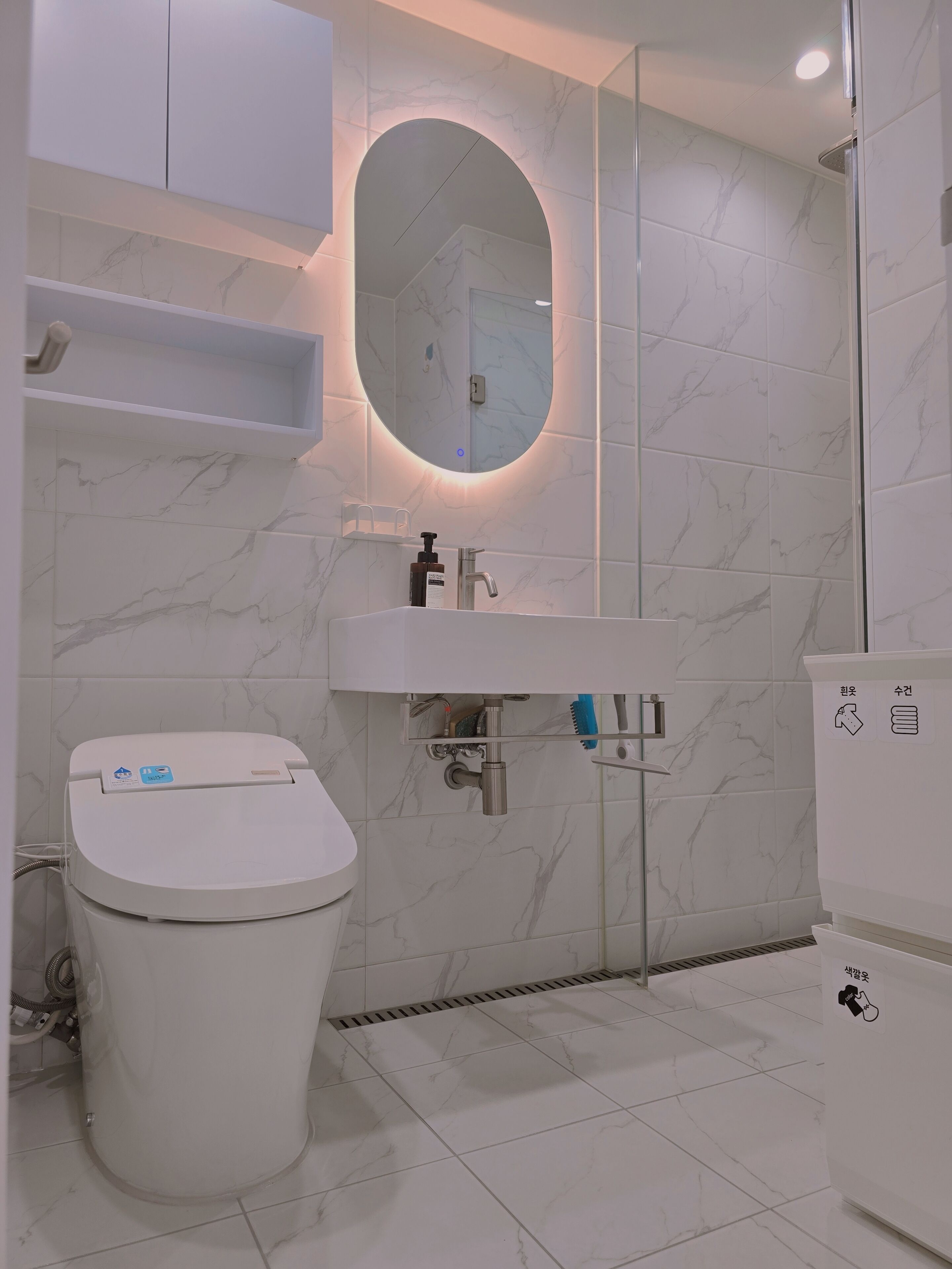 Ein modernes Badezimmer mit Toilette, Waschbecken und Dusche.