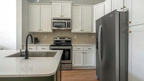 Fridge, dining tables - Landing | Stylish 1BD, Rooftop Lounge, Gym (Cary)