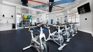 A gym with stationary bikes, weight machines, and exercise balls. - Landing | Amazing 2BD, Pool, Clubhouse (Kissimmee)