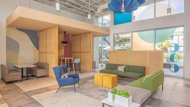 A modern lounge area with a sofa, armchairs, and a small table. - Landing | Amazing 1BD, Pool, Clubhouse (Goodyear)