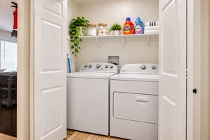 Your own in-unit washer and dryer keeps everything fresh and convenient. A tidy shelf with detergent, storage jars, and cheerful greenery adds a homey touch to your laundry routine. - Seaside Escape + Walk to Encinitas Beach + Wifi + Free Parking (Encinitas)