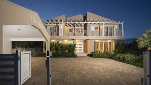 A two-story villa with a covered patio, a gated driveway, and a landscaped front yard. - Villa Bella near the sea with Private Pool, Sauna, and Hot Tub (Ližnjan)