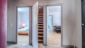 A modern interior with a staircase leading to a bedroom with a bed and a nightstand. - La Pinède, a welcoming family home, 5 minutes from Vallon Pont D'Arc (salavas)