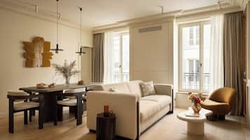 Deluxe Apartment | Living area | 32-inch Smart TV with cable channels, Netflix, books