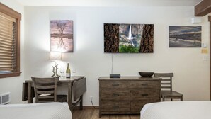 A bedroom with two beds, a desk with a chair, a dresser, and artwork on the walls. - Lake Escape Room: Min to Lake/Pool/HotTub/Sauna (Placer County)