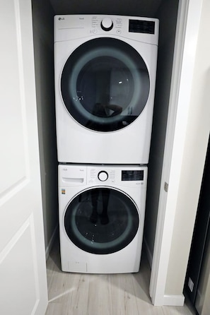 Convenient laundry facilities with two front-loading washing machines.