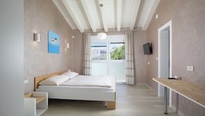 A modern bedroom with a bed, bedside table, and a view of the outdoors. - Villa Olivia with Private Pool, Sauna, and Hot Tub – Just 800m from the Beach (Ližnjan)