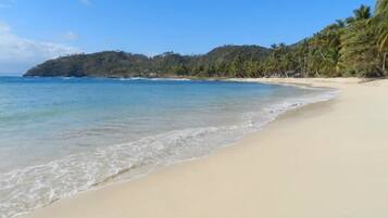 On the beach, sun loungers, beach towels