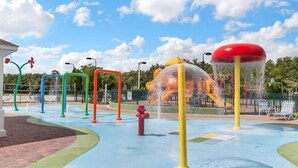 A water play area with colorful structures and a red fire hydrant. - 4 Bedroom 3 Bathroom Villas At Seven Dwarfs 12-108 (Kissimmee)