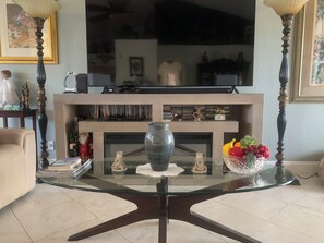 Relax in style with a comfortable armchair, large flat-screen TV, and a warm fireplace.