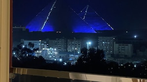 A nighttime view of a stadium with illuminated structures.