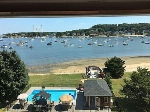 Vanderbilt area waterfront estate 3 bedroom 3.5 bath with fitness room & pool