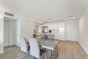 Un apartamento moderno con comedor, cocina y un espacio de sala independiente.