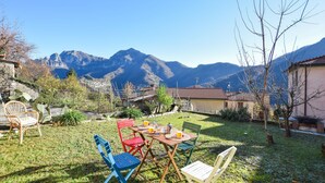 A patio with a table and chairs, a cactus, and a mountain view. - Gorgeous home in Farnocchia with WiFi (Farnocchia)