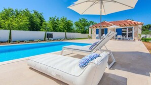 A pool area with two white lounge chairs, one with a blue and white towel. - Stunning home in Privlaka with private swimming pool, can be inside or outside (Privlaka)