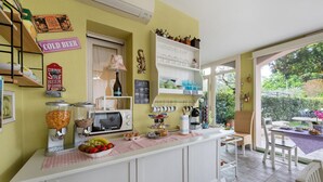 A kitchen counter with a coffee machine, a microwave, and a fruit bowl.
