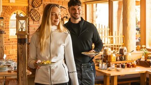 A rustic interior with exposed wooden beams, a brick wall, and a wooden table with jars and utensils. - Room 'Rossalm Panoramic Room 4' with Shared Terrace, Shared Garden and Wi-Fi (Brixen)
