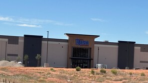 A large building with a sign reading 'The Rush Complex.'