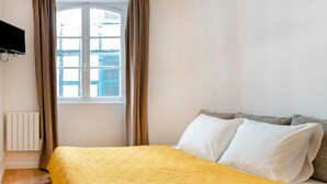 Tabla de planchar con plancha y ropa de cama