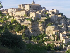 A historic town built on a hillside with stone buildings and narrow streets.