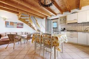 A kitchen with white cabinets, a tiled backsplash, and a wooden ceiling. - Holiday Home 'Lago' with Lake View and Private Terrace (Brenzone sul Garda)