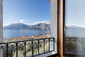 A balcony with a view of a lake and mountains.