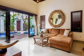 Deluxe Suite, 2 Bedrooms, Pool View | Living area | Flat-screen TV