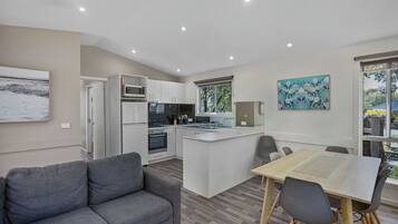 Family Triple Room | Living area | 32-inch TV with digital channels